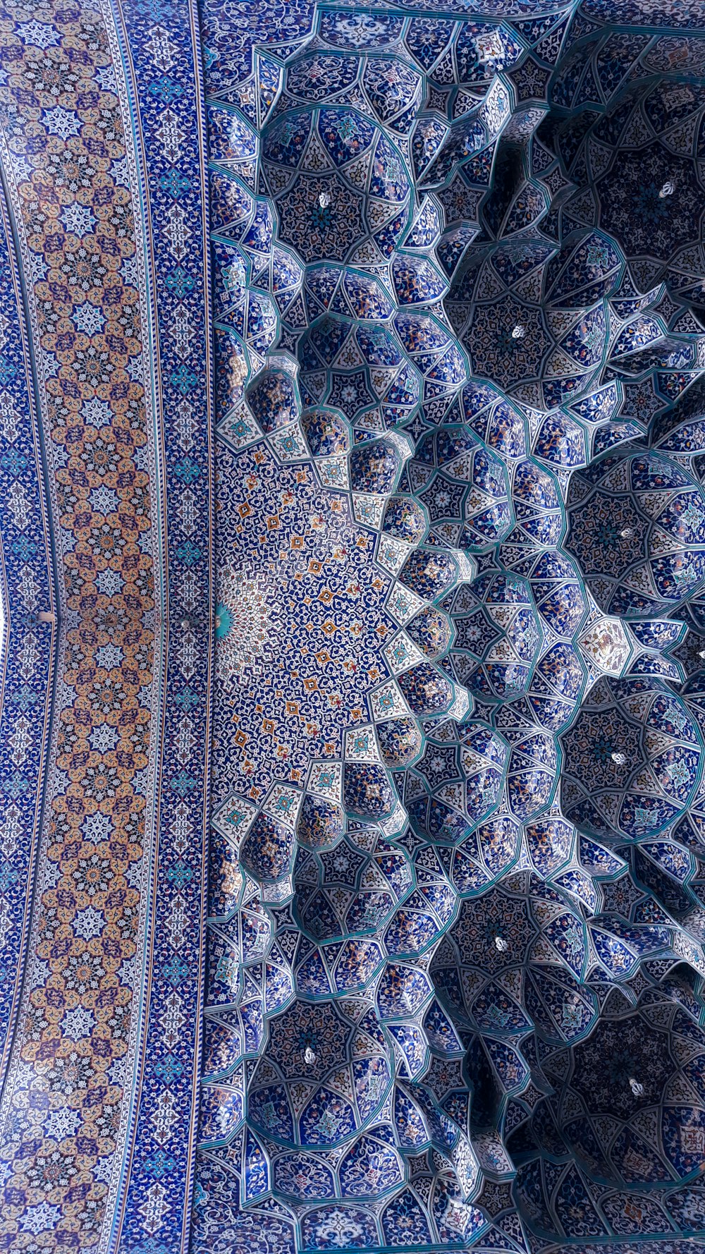 an intricate blue and white pattern on a wall