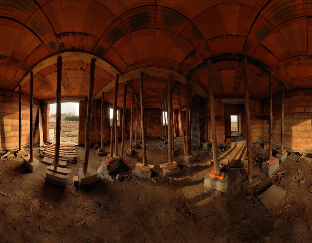 the inside of a building with wooden beams and benches