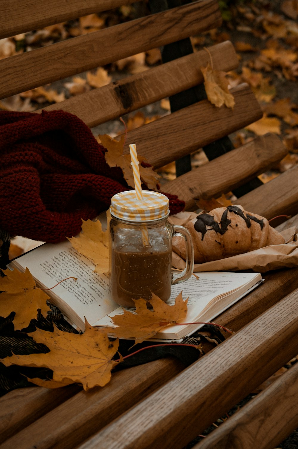 a jar of coffee sitting on top of a wooden bench