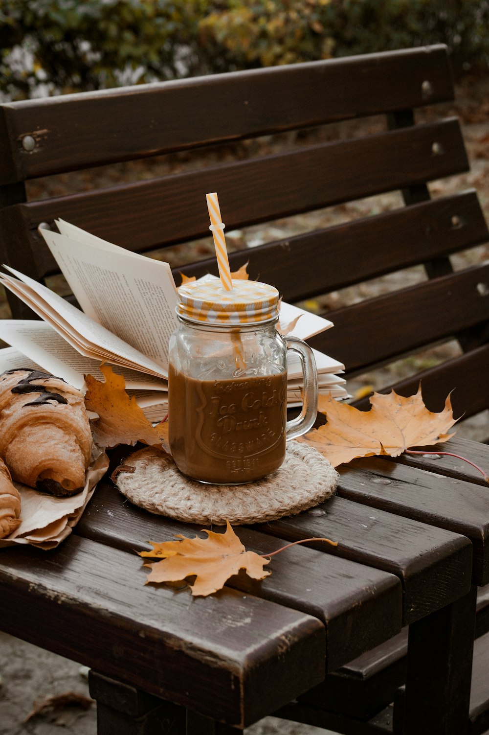 a jar of coffee sitting on top of a wooden bench
