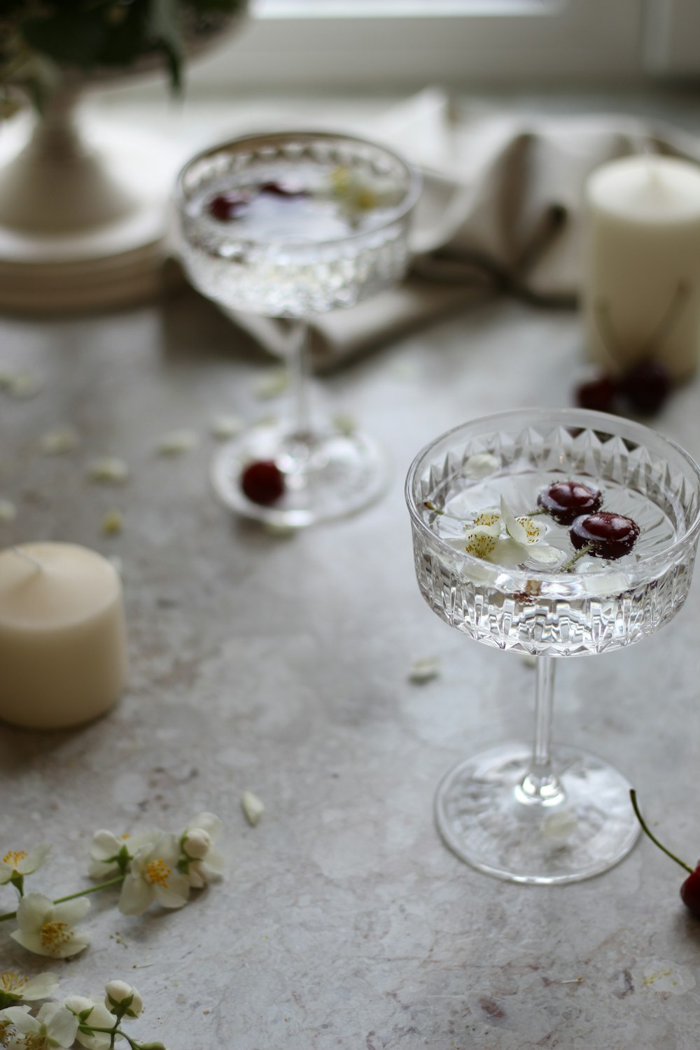 a table topped with two wine glasses filled with liquid