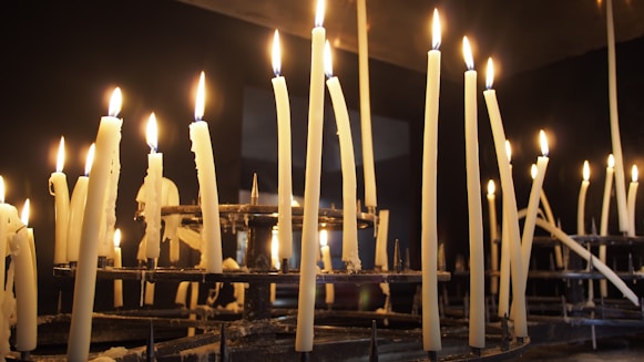 a row of lit candles in a church
