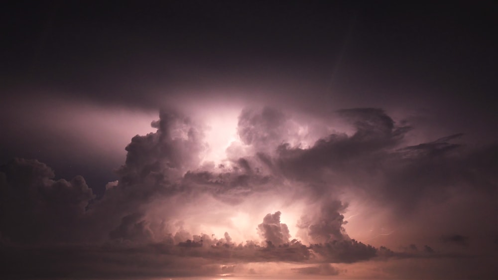 a storm is coming in over a body of water