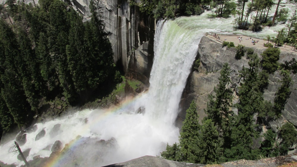 a waterfall with a rainbow in the middle of it