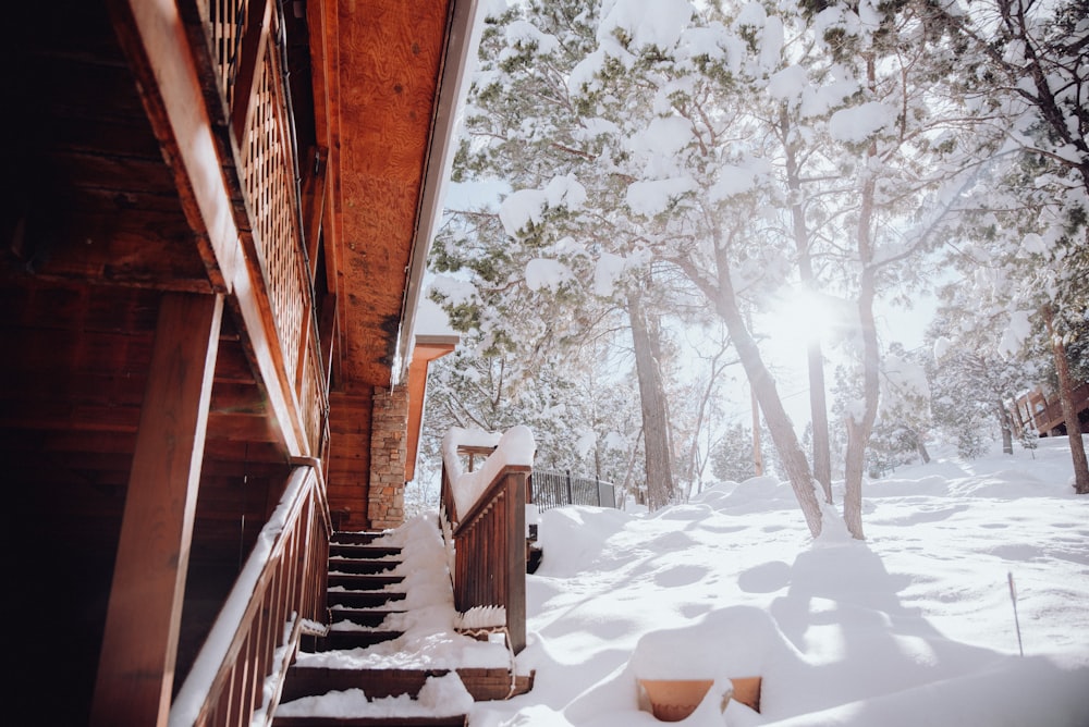 a snow covered staircase leading to a cabin