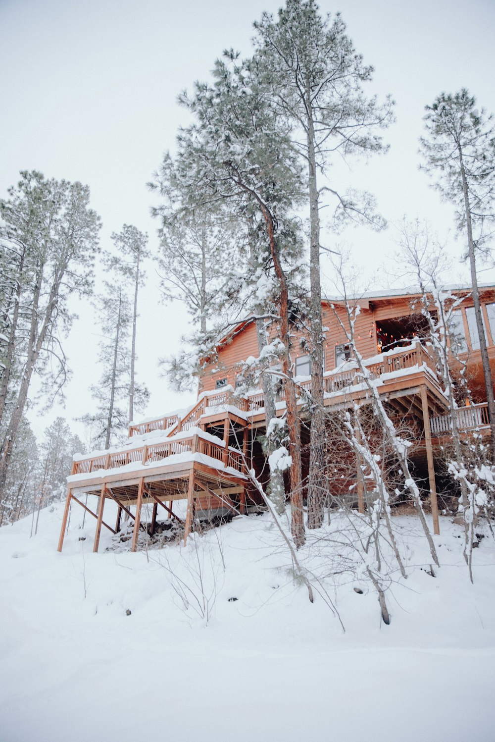 a house in the woods covered in snow