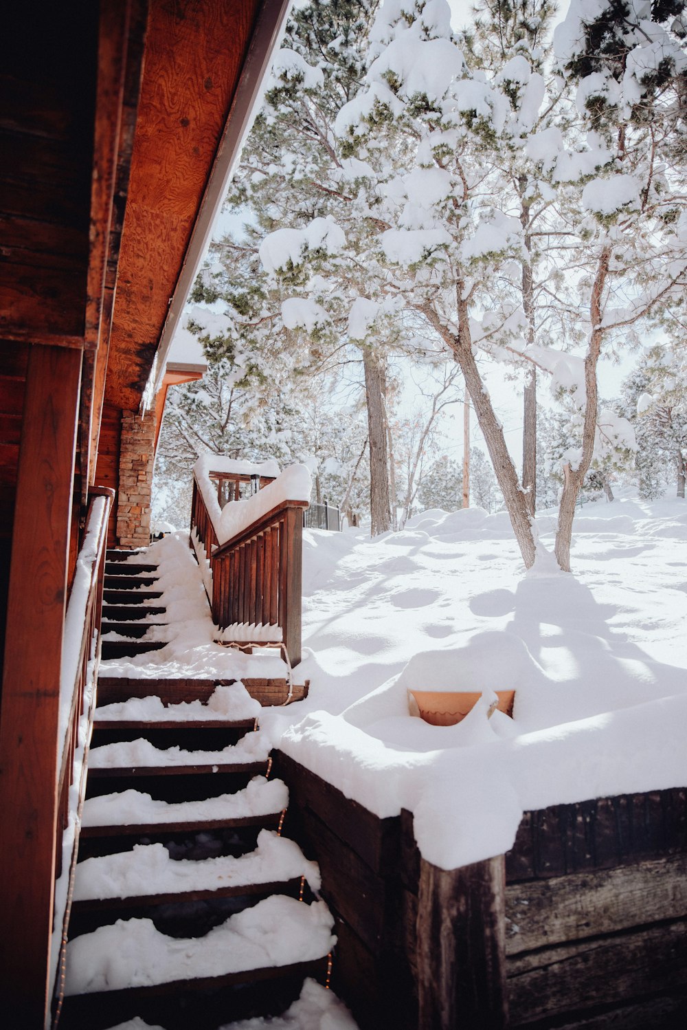 a snow covered staircase leading to a cabin