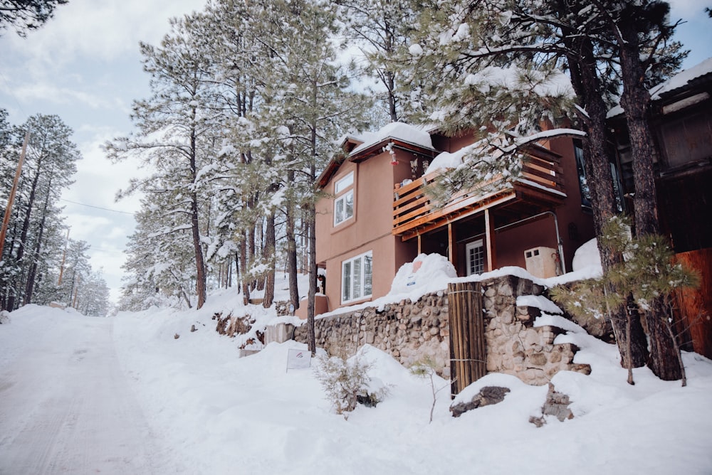 a house in the woods covered in snow