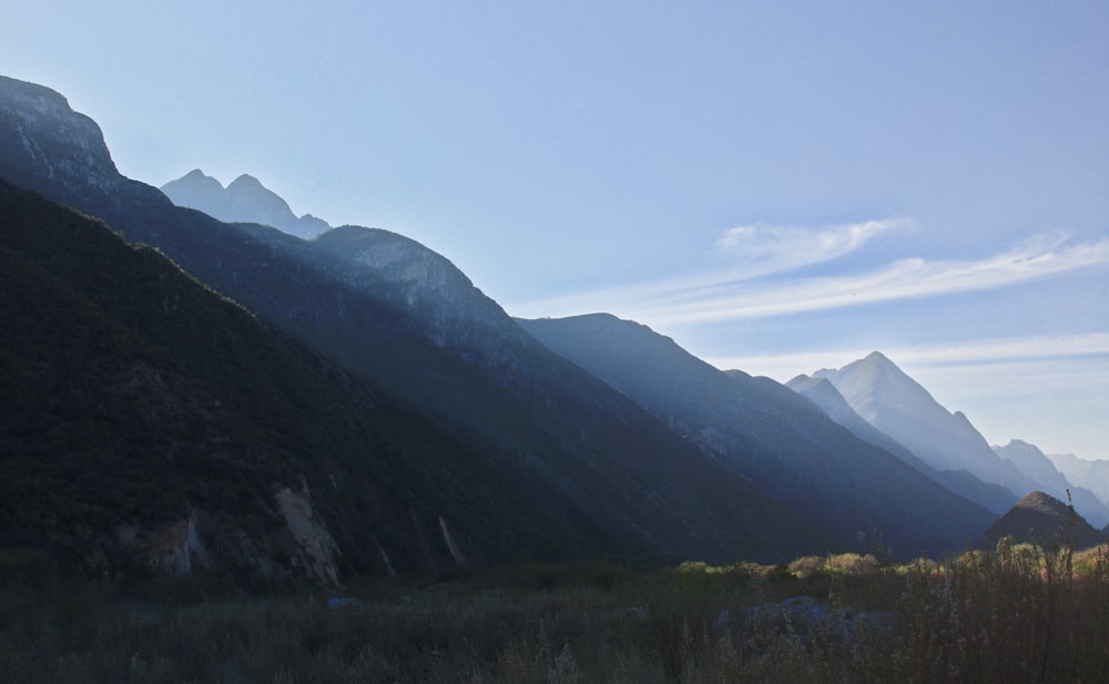 a view of a valley with mountains in the background