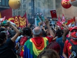 A political rally with enthusiastic supporters waving flags.