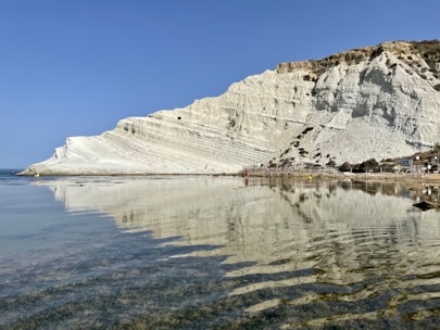 a body of water with a mountain in the background