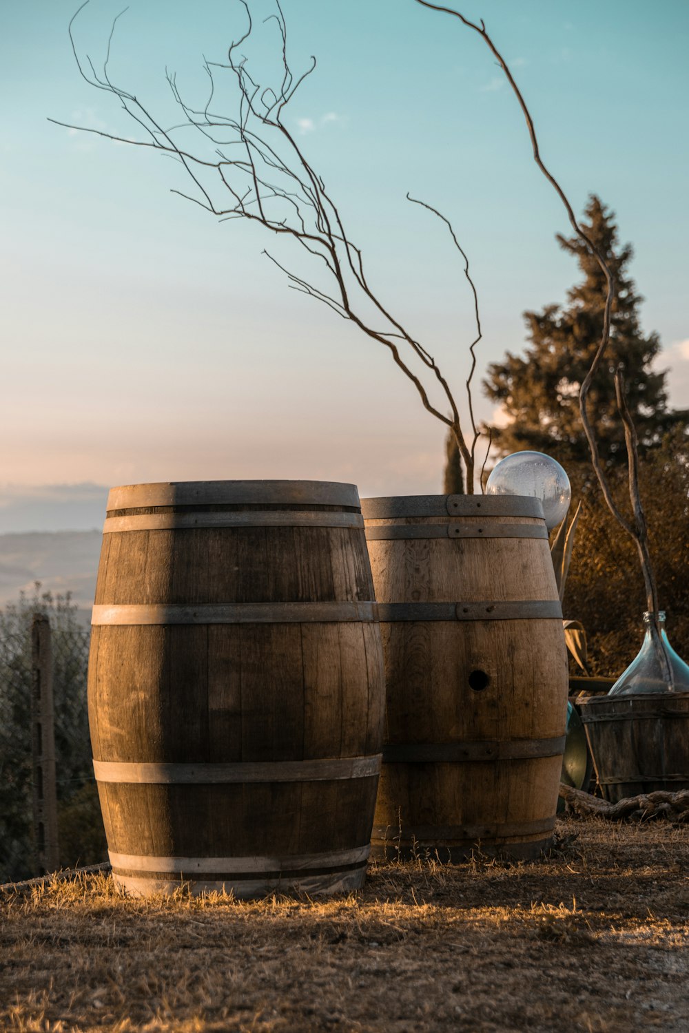 a couple of wooden barrels sitting on top of a field
