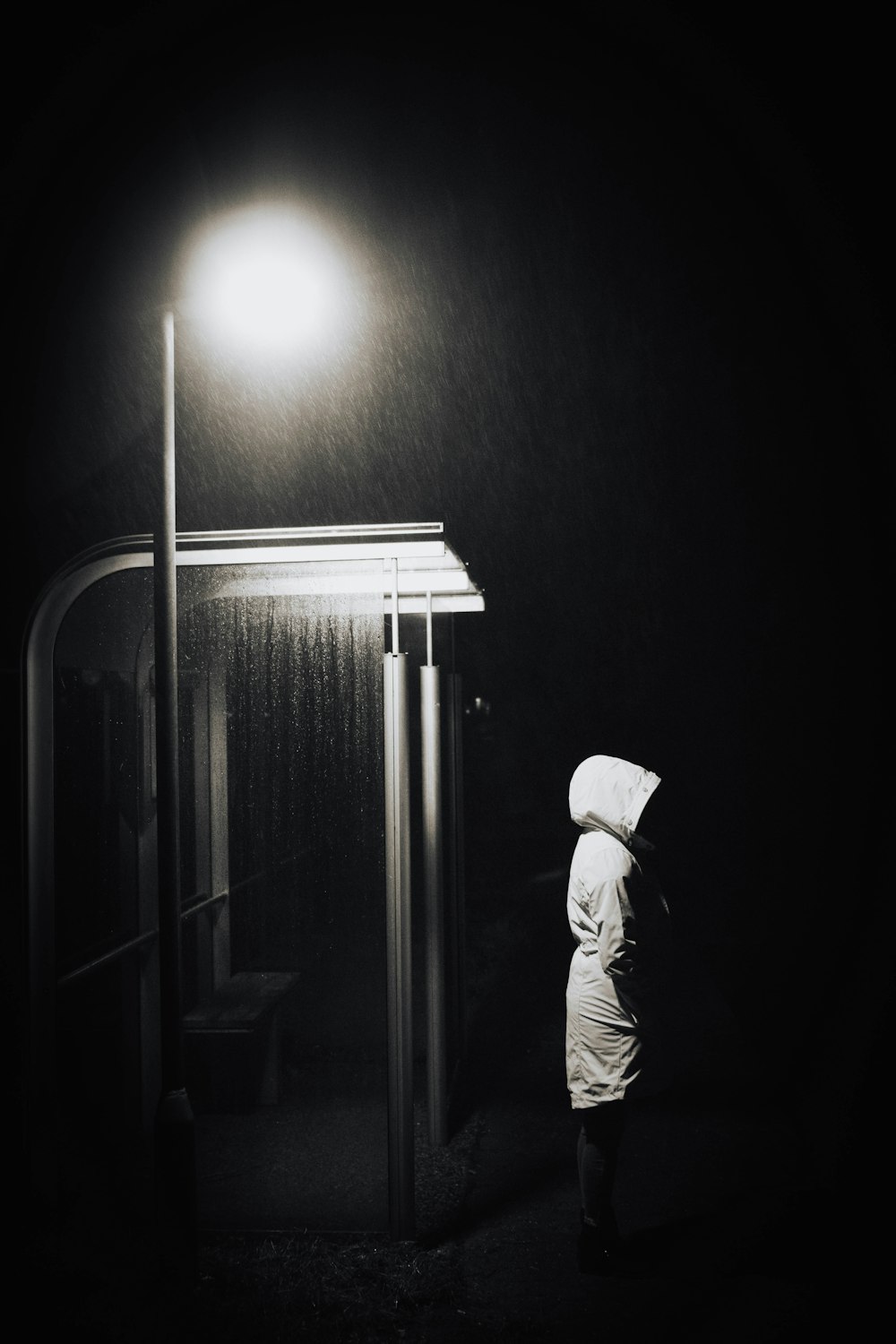 a person standing under a street light in the dark