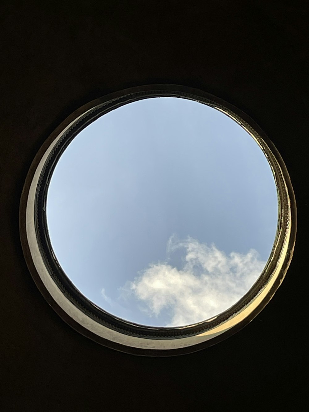 a round window with a view of the sky