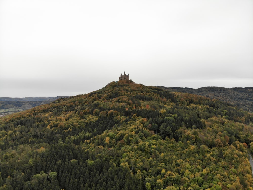 a large hill with a tower on top of it