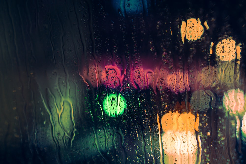 a traffic light seen through a rainy window