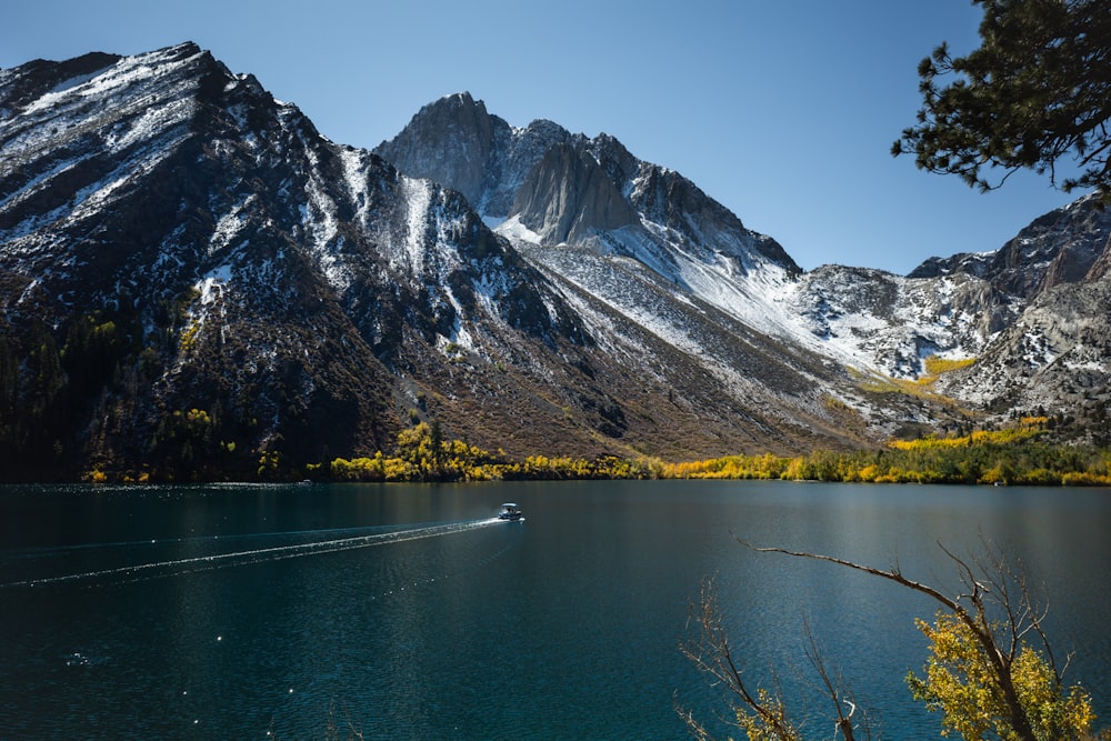 a boat in the water near a mountain range