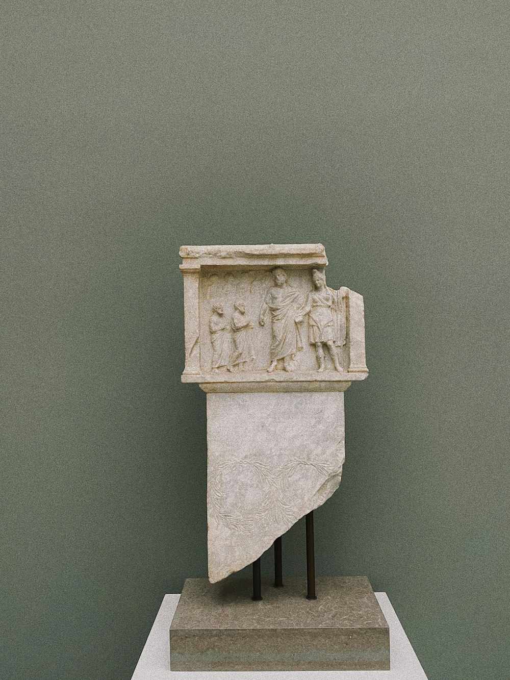 a sculpture of a rectangle with figures on it