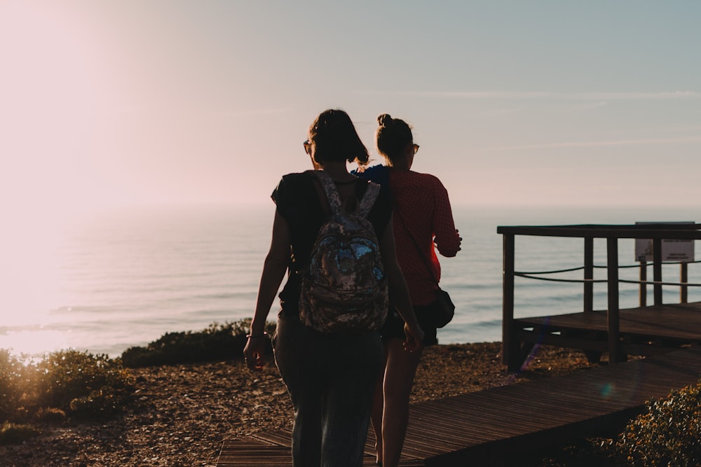 a couple of people that are walking down a path