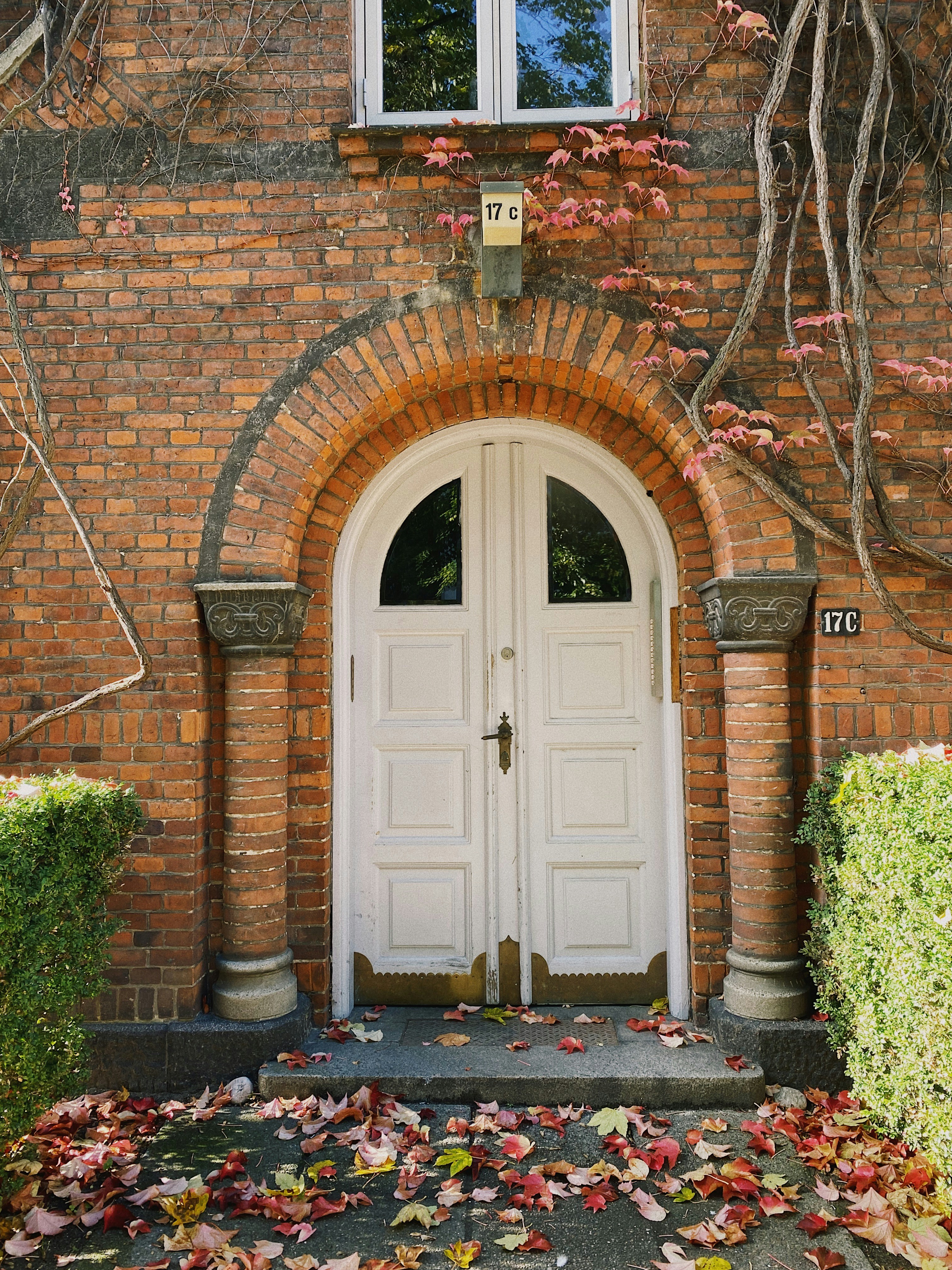a brick building with a white door and window
