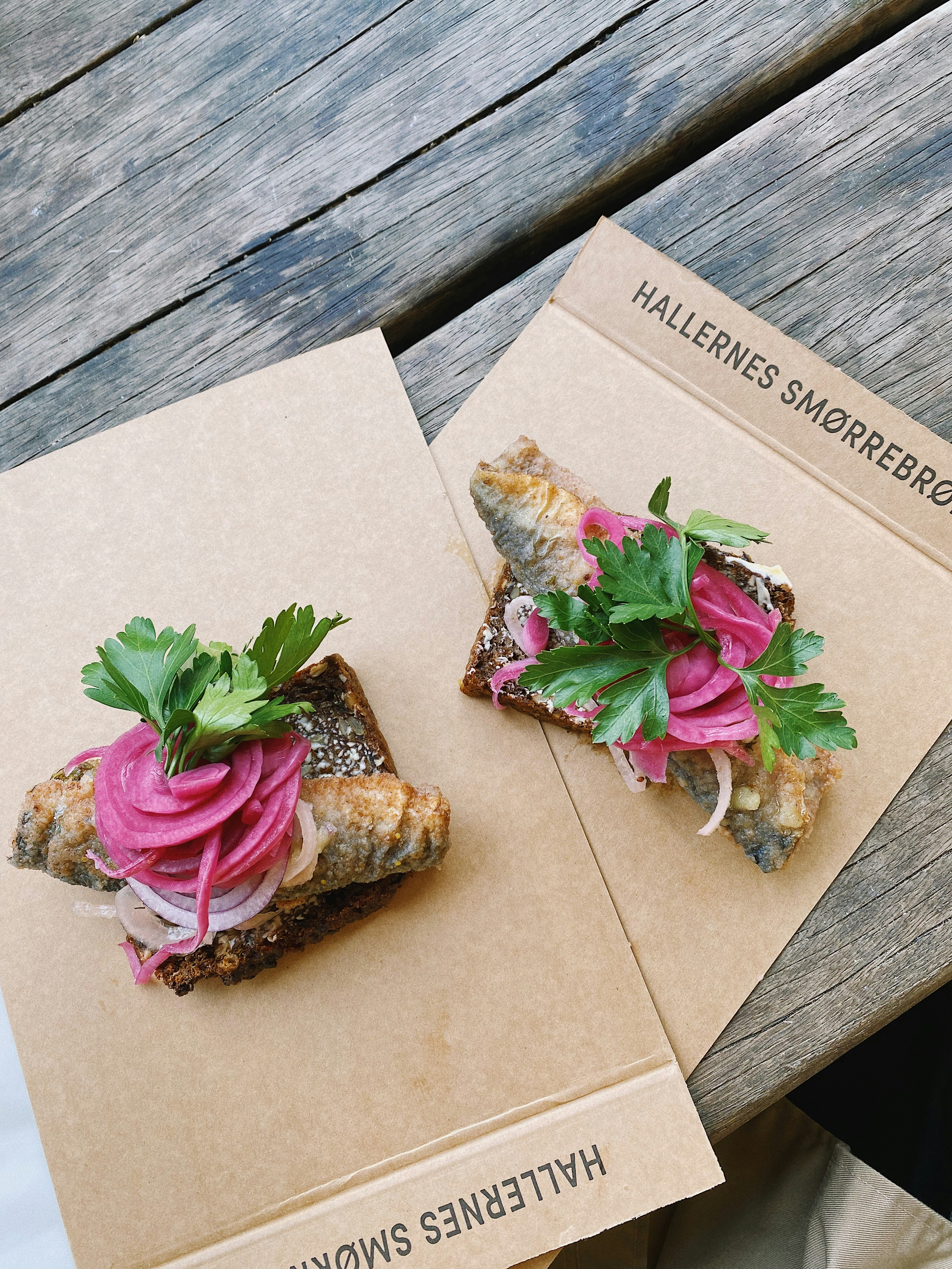 a couple of sandwiches sitting on top of a wooden table