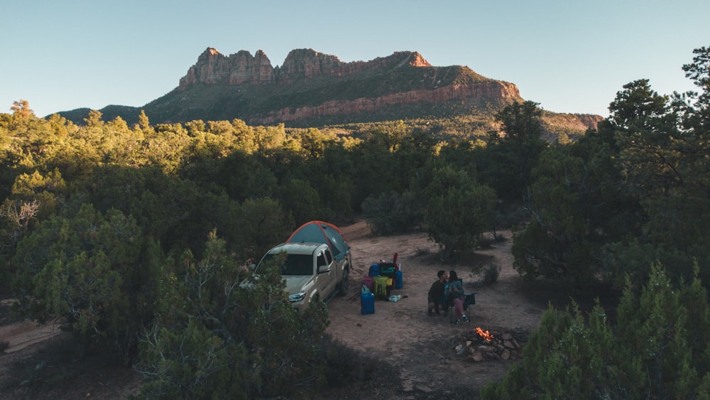 a group of people standing around a camp site