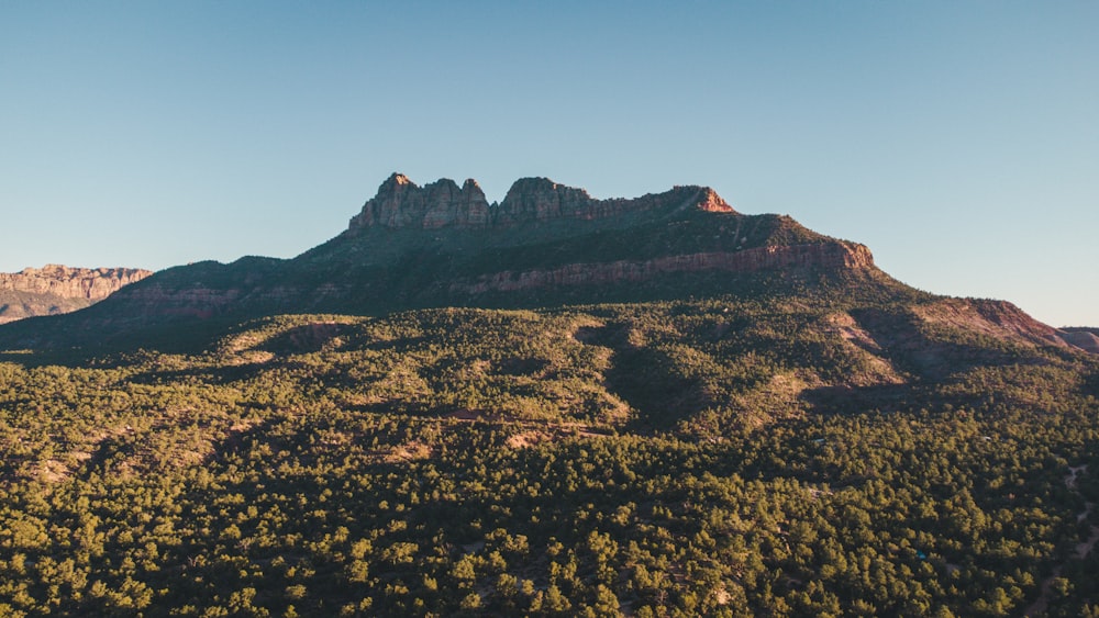 a view of a mountain range with trees and mountains in the background