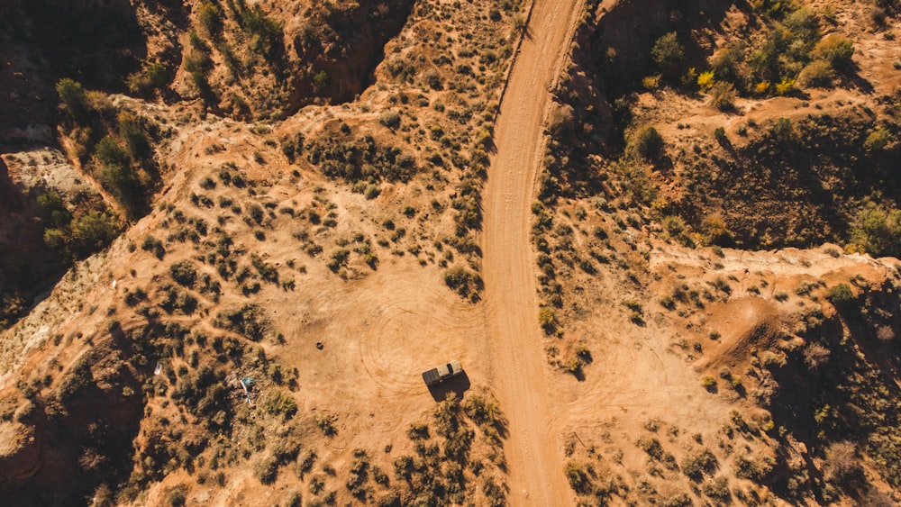 an aerial view of a dirt road in the desert