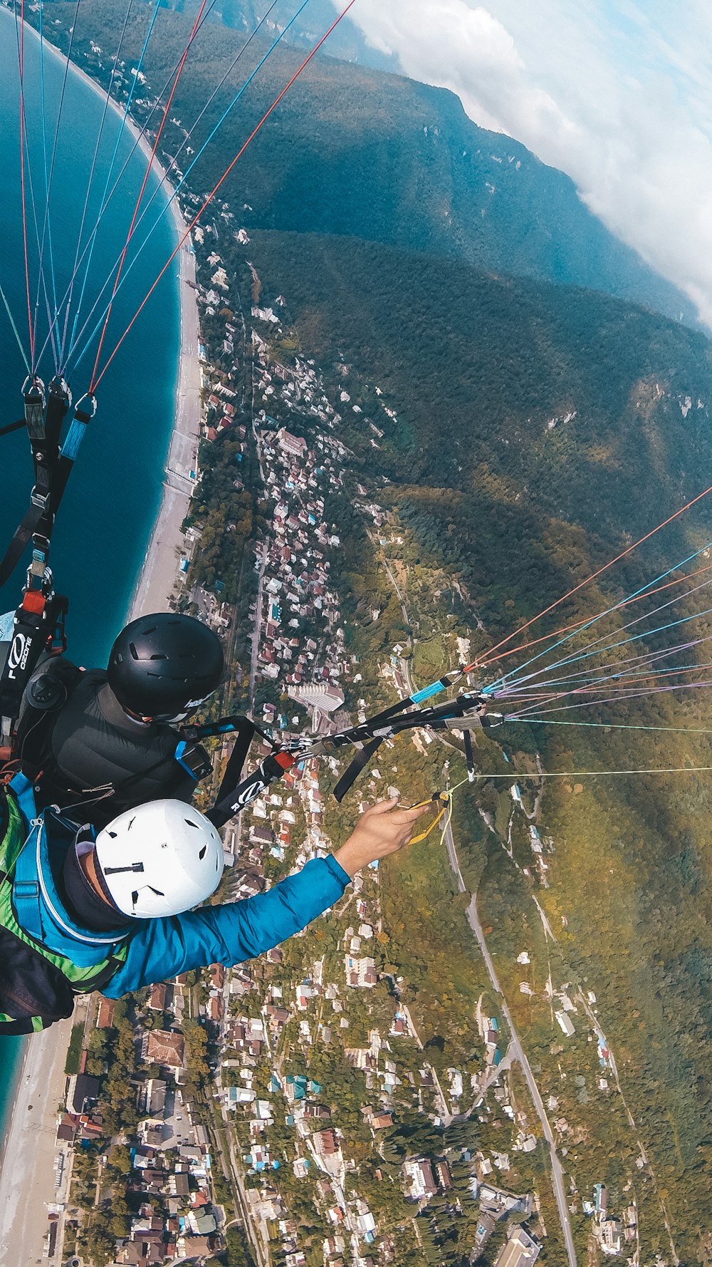 a man flying through the air while riding a parachute