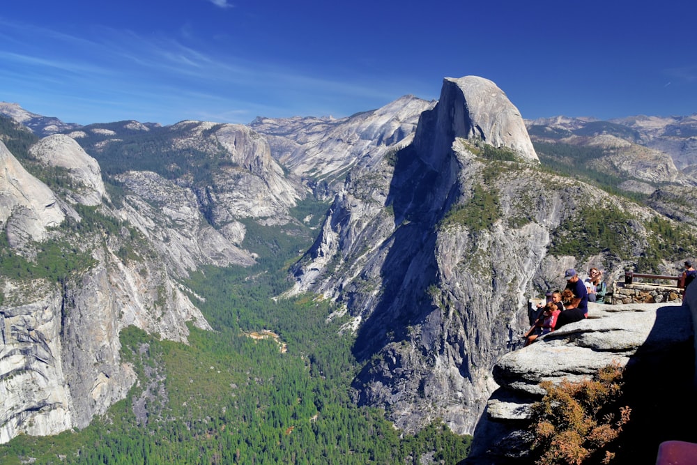 a group of people sitting on top of a mountain