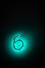 a close up of a neon sign on a wall
