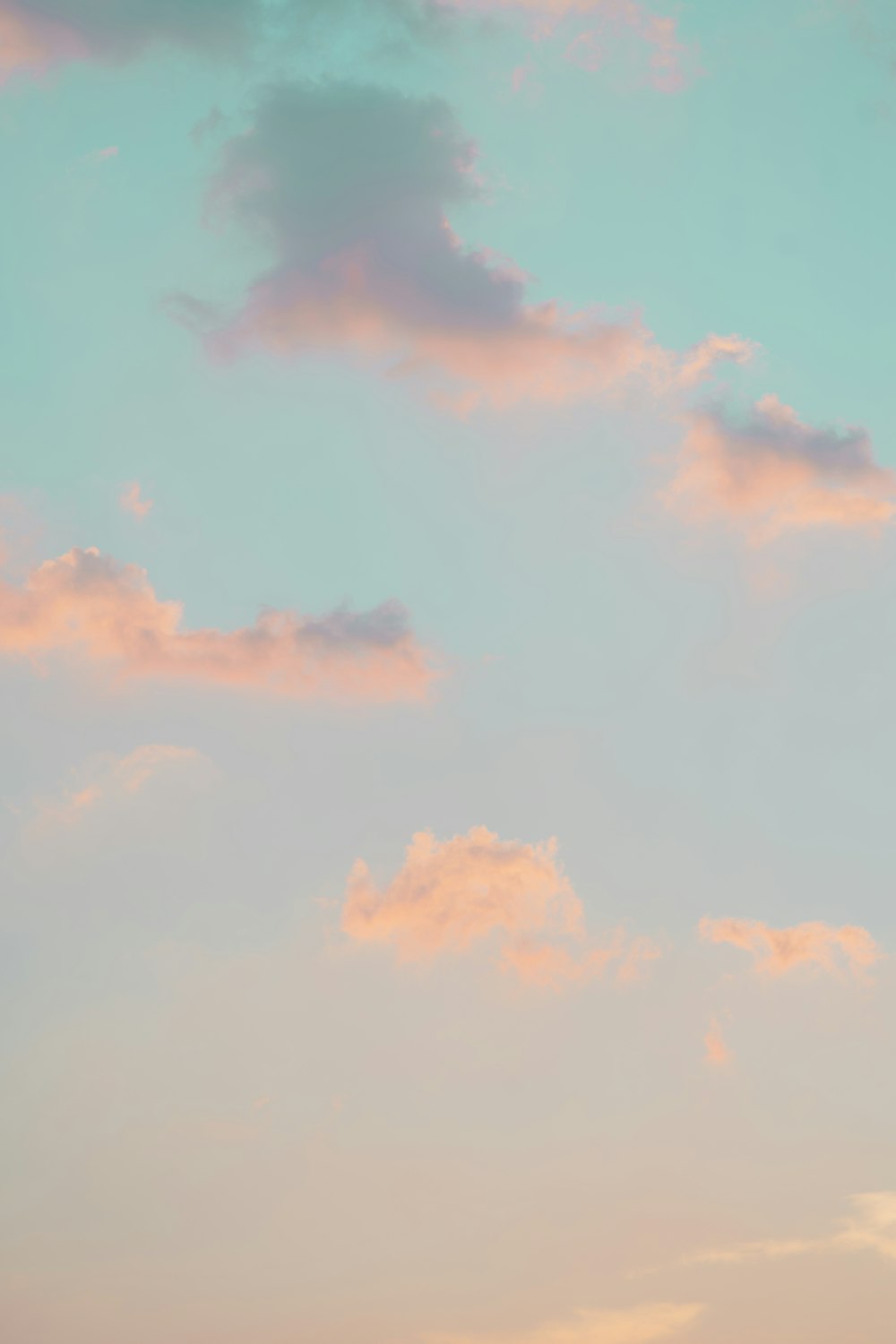 a plane flying in the sky at sunset