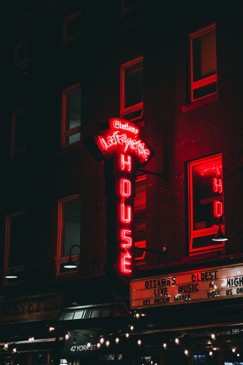 a red neon sign on the side of a building