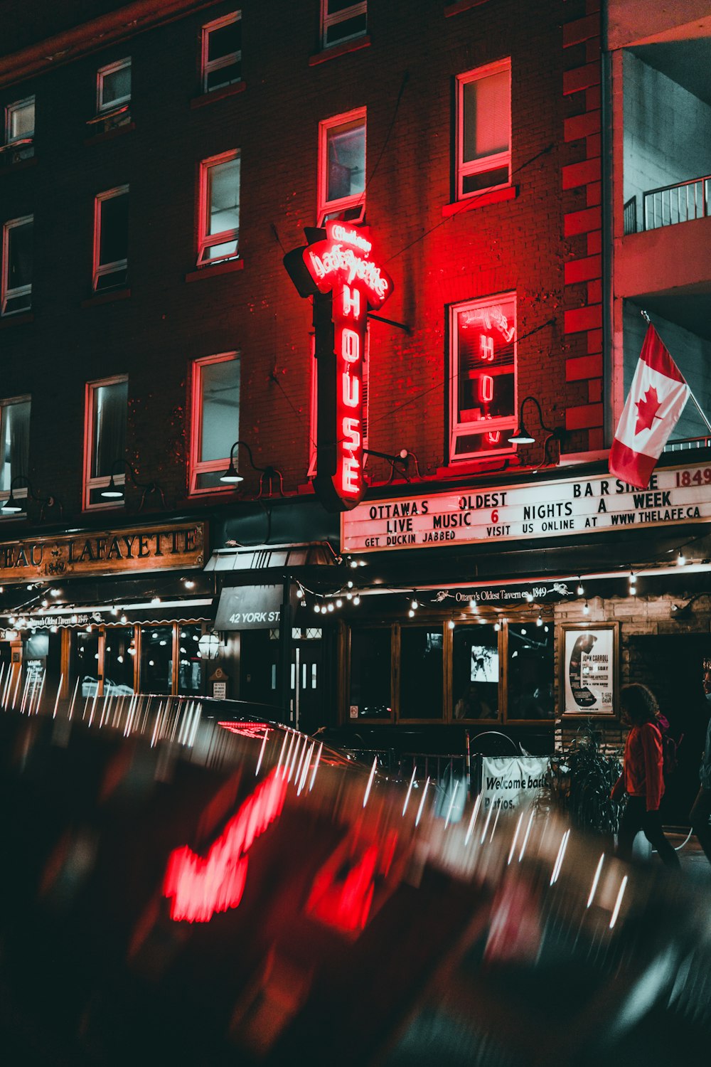 a red neon sign on the side of a building