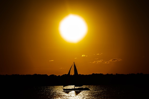 Sunset casting golden light over a sleek boat sailing near Mallorca’s coastline.