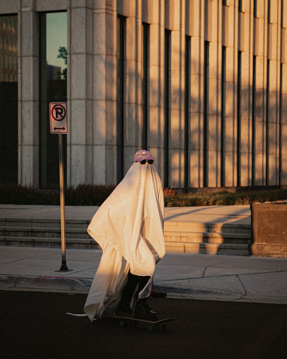 a person on a skateboard wrapped in a sheet