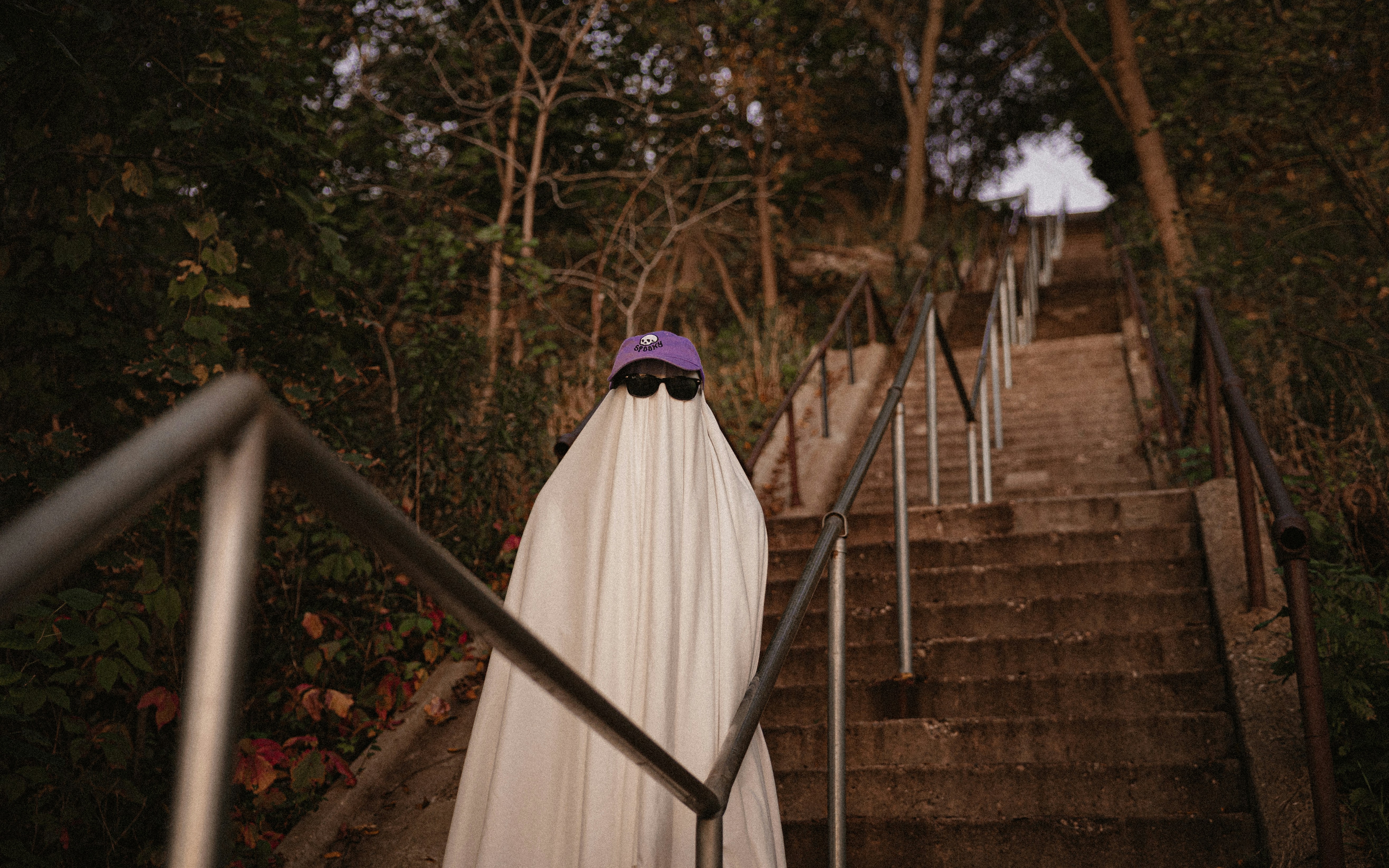 a woman in a white dress standing on a set of stairs