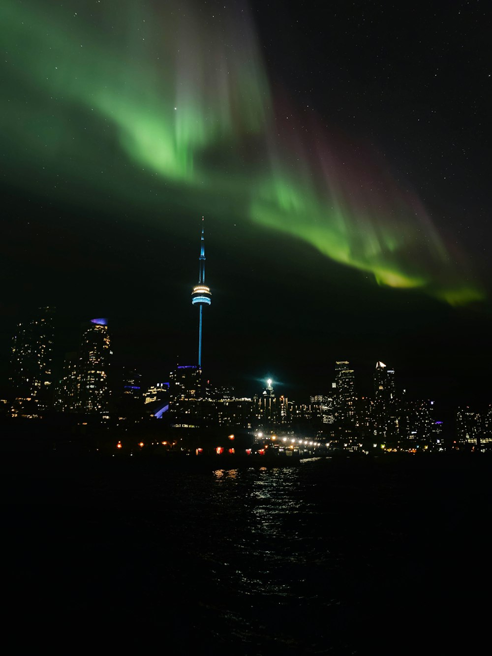 the aurora lights over the city skyline at night