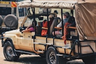 a group of people riding in the back of a truck