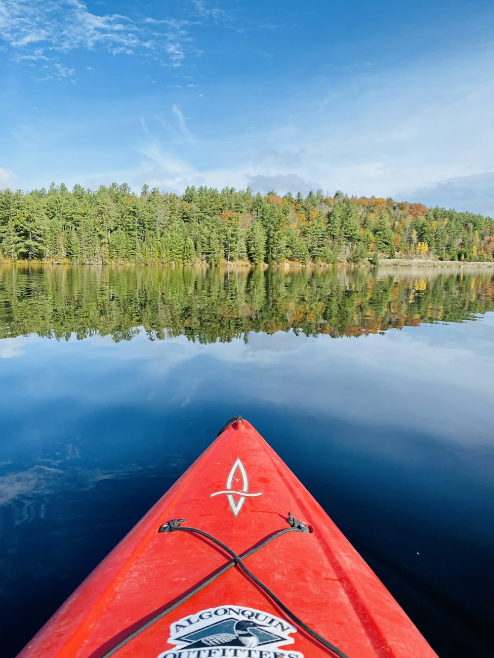 a red kayak in the middle of a lake