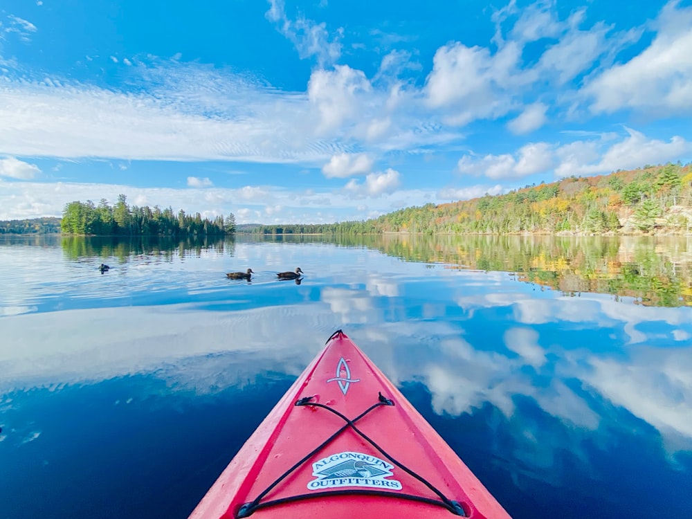 a red kayak in the middle of a lake