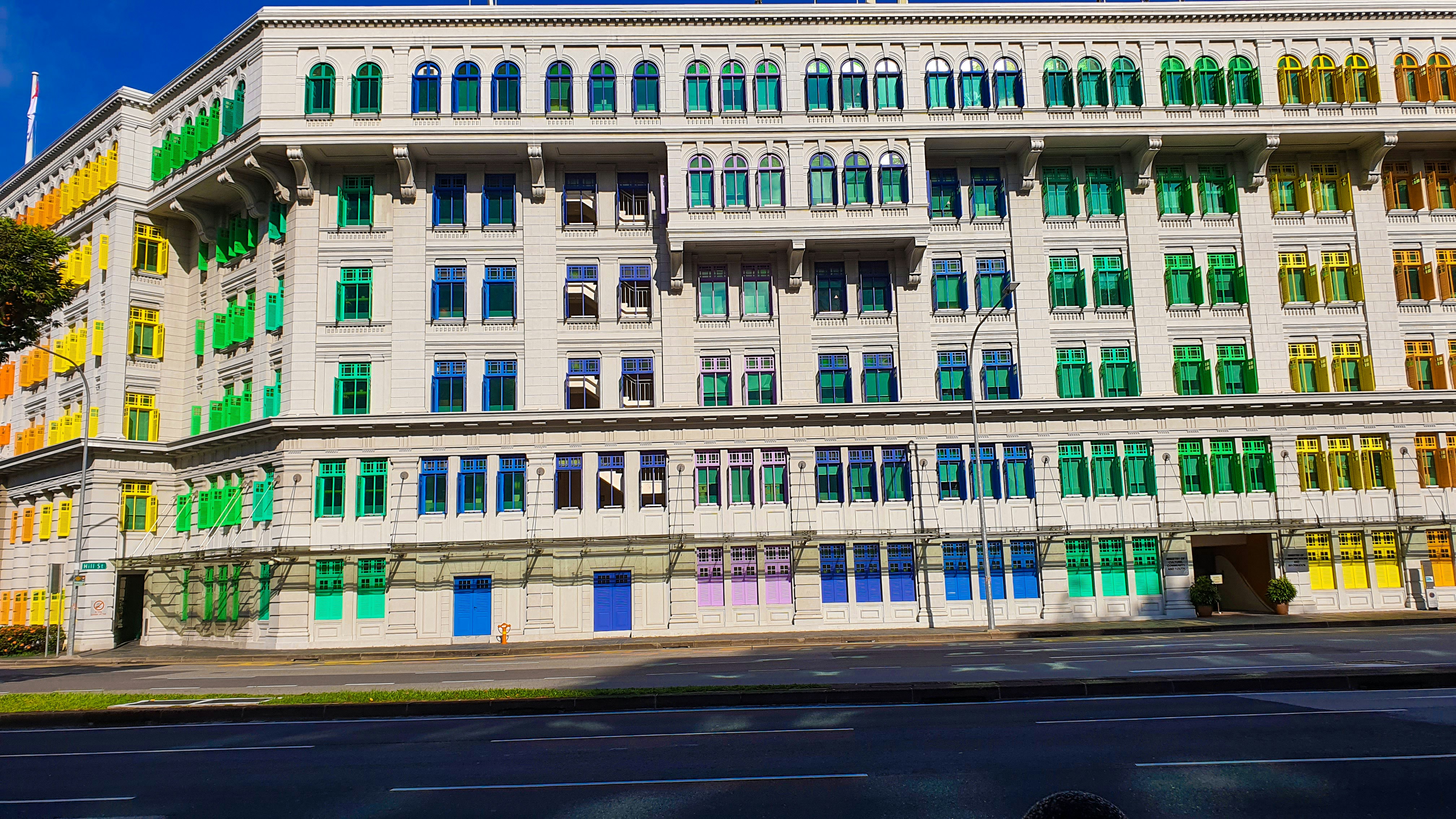 a multicolored building on the corner of a street