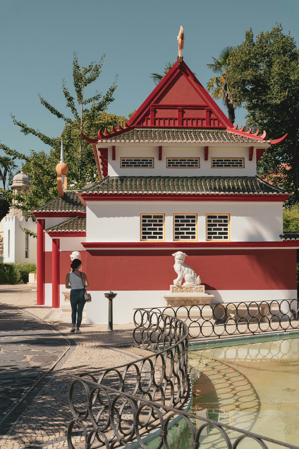 a woman standing in front of a red and white building