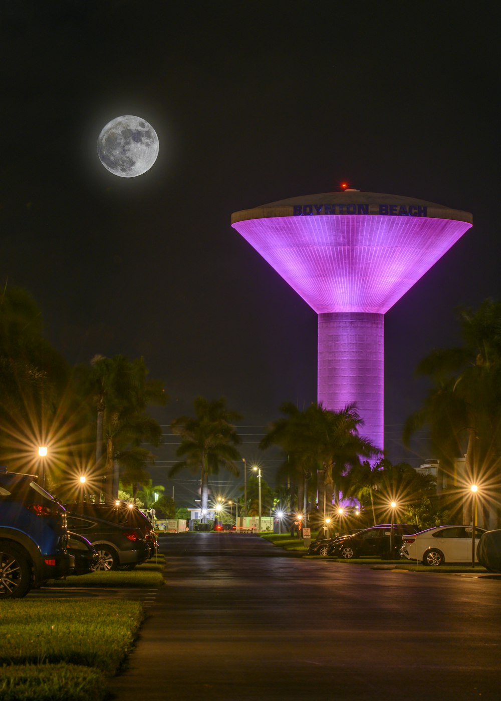 a very tall tower with a purple light on it's side