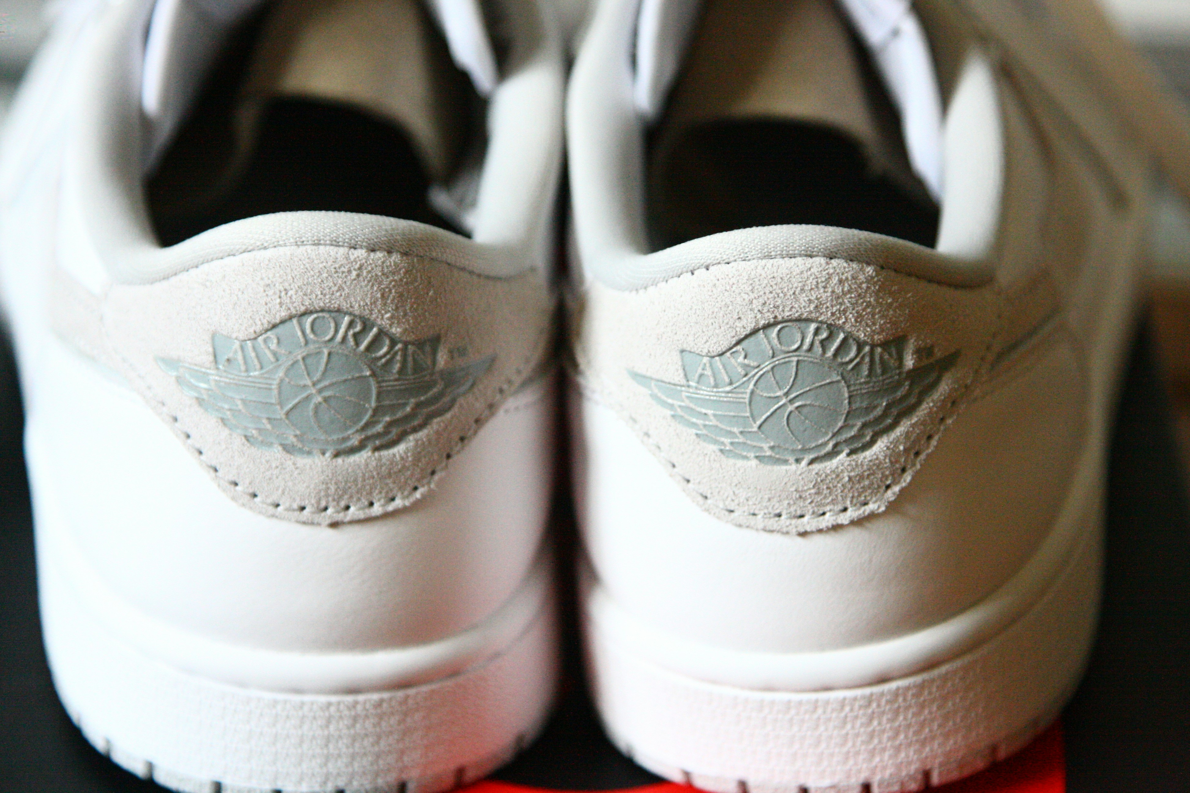 a pair of white sneakers sitting on top of a table