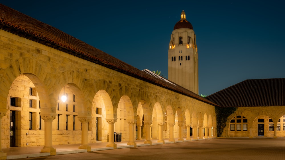 a large building with a clock tower in the background