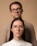 a man and a woman with glasses standing next to each other