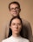a man and a woman with glasses standing next to each other