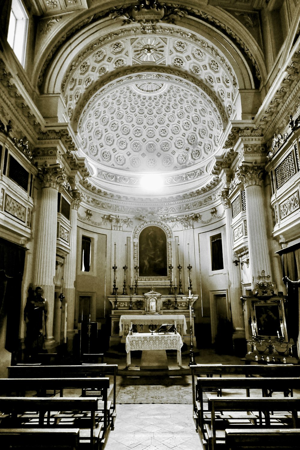 a black and white photo of a church with pews