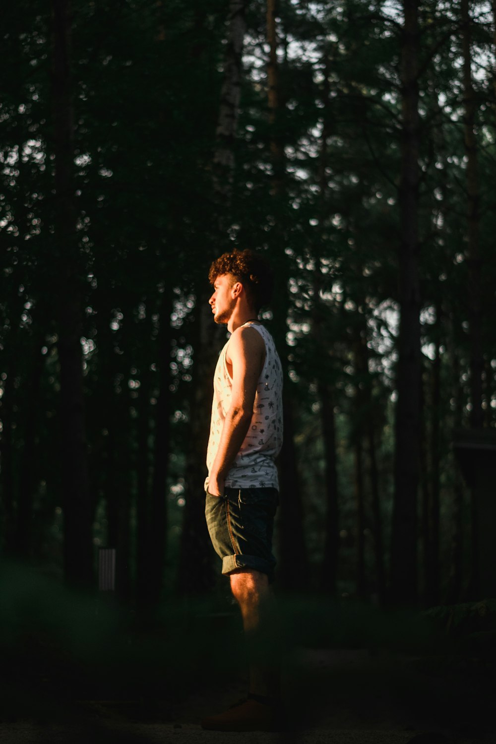 a man standing in front of a forest